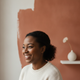 Portrait of a smiling woman in her thirties, representing a happy, trusted customer.