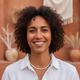 Headshot of a smiling person, conveying happiness and trust.